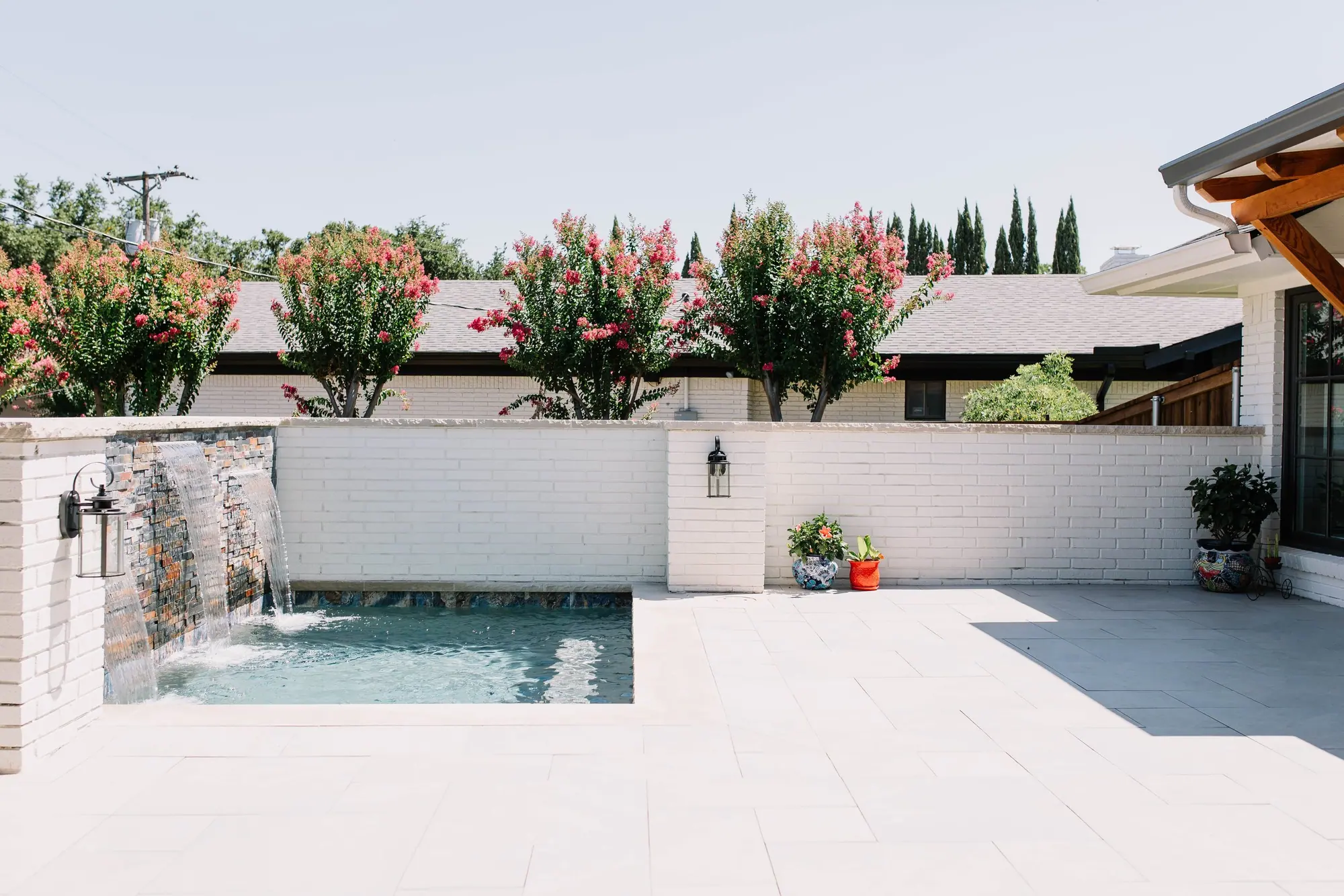 Outdoor living: backyard patio with a plunge pool and waterfall feature in Fort Worth