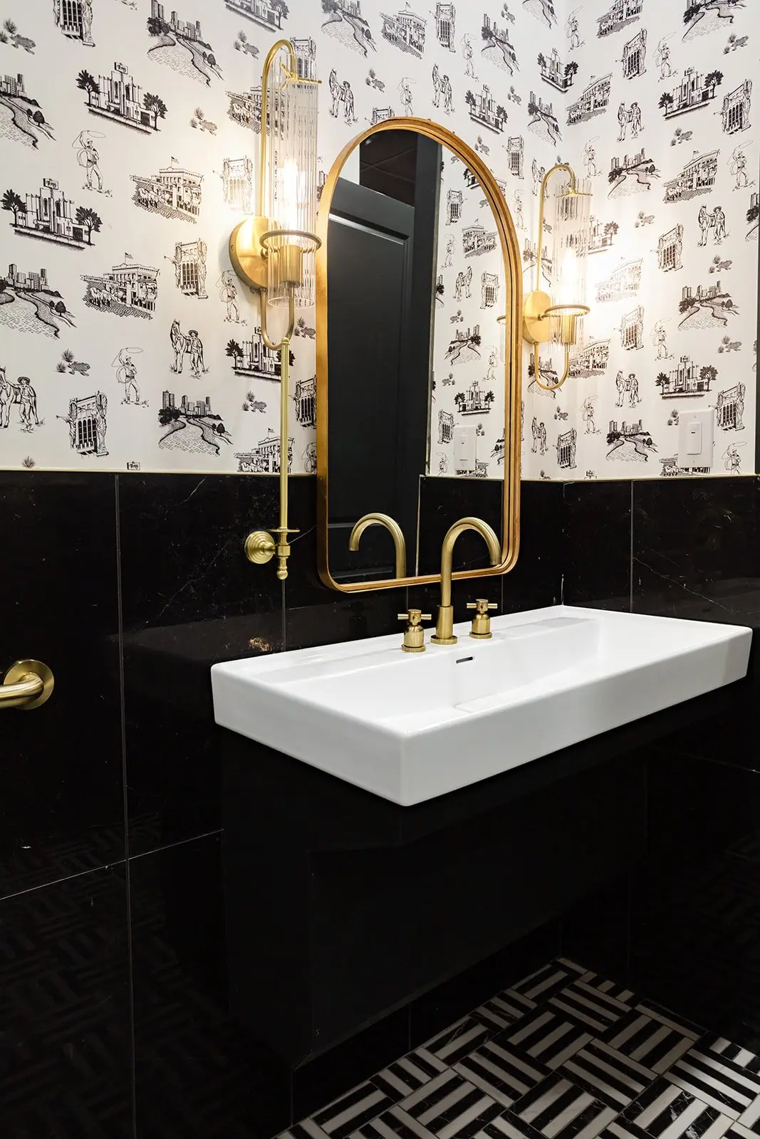 Bath renovation with black tile and patterned wallpaper in a Fort Worth home