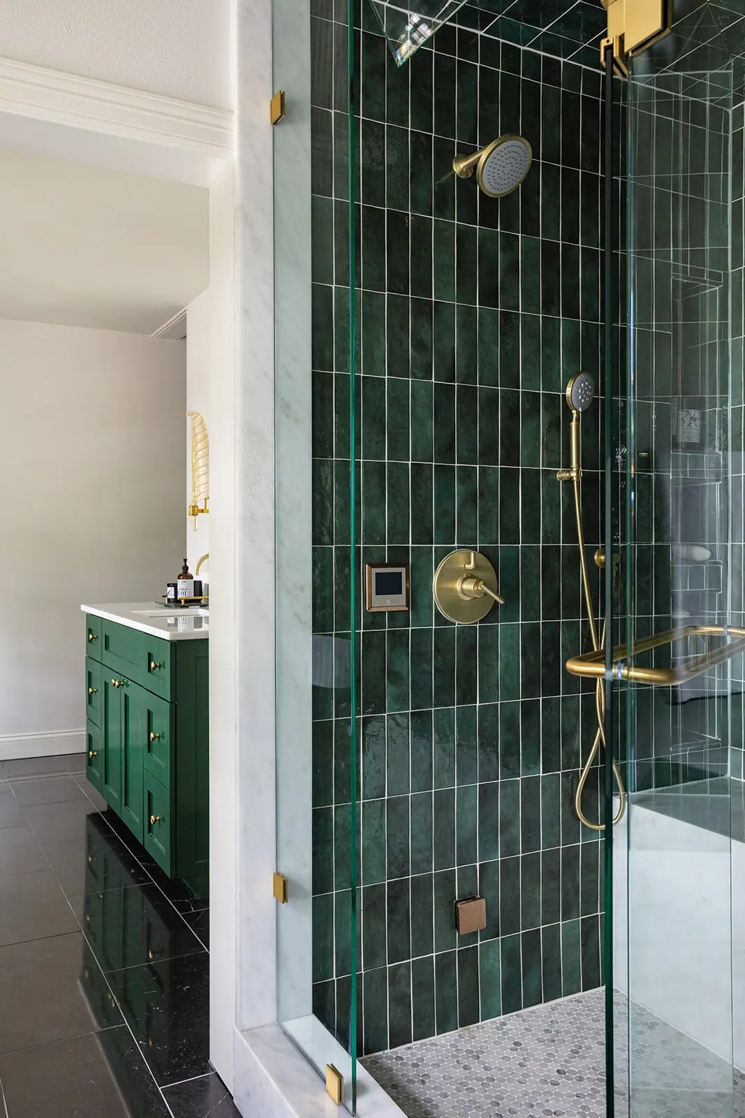 Walk-in shower with emerald tile and brass fixtures in a Fort Worth primary bath remodel