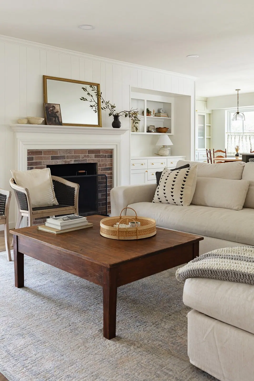 Living room with brick fireplace in a completed Fairmount whole-home renovation
