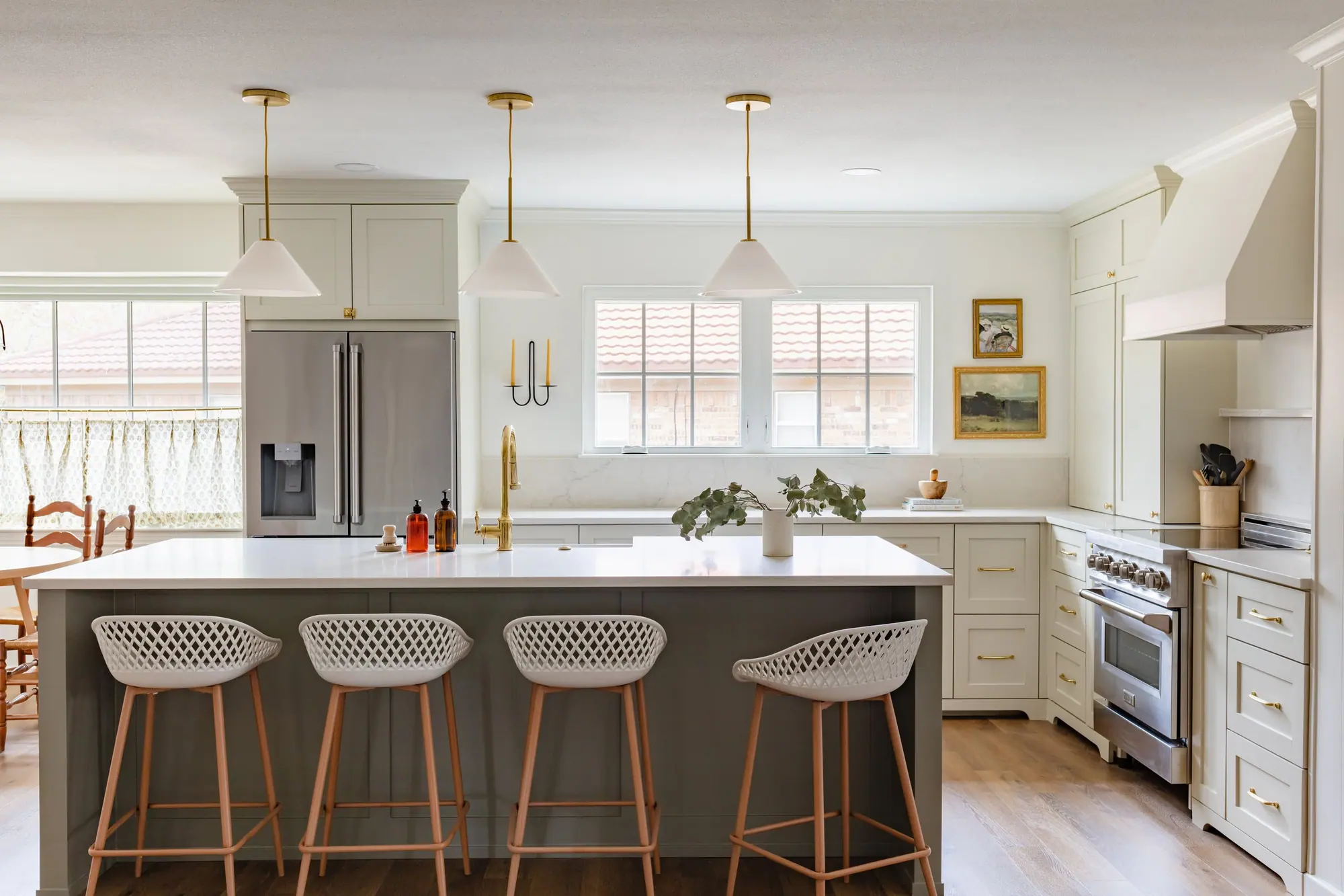 Bright kitchen renovation with white cabinets and a large island in Fairmount