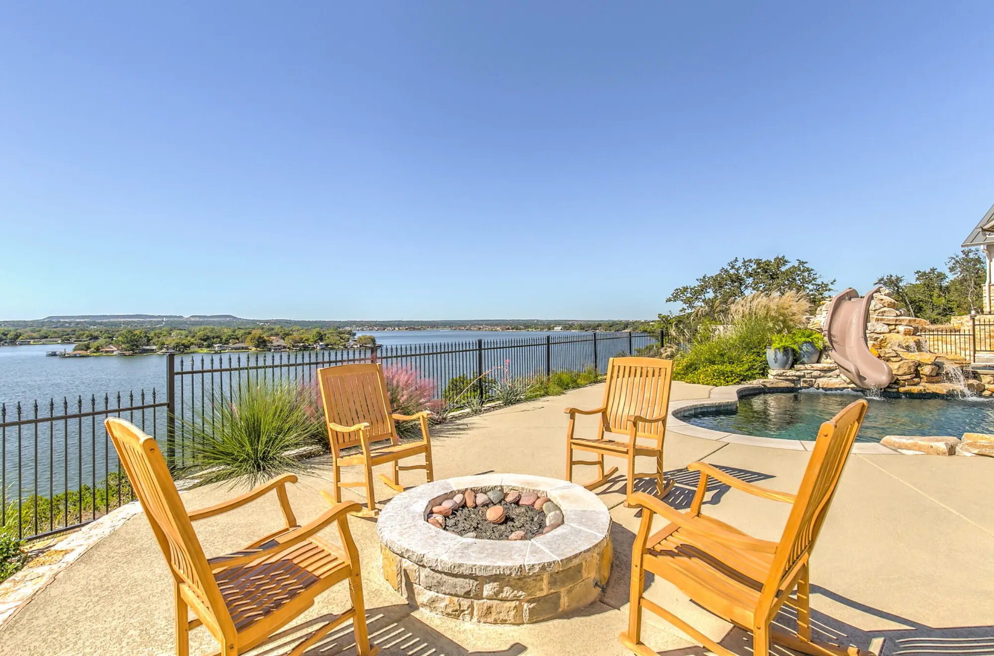 A lakeside terrace and pool on a 6th Ave Homes outdoor-living build near Fort Worth