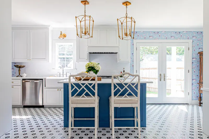 A remodeled Fort Worth kitchen with a navy island, brass lanterns, and graphic tile floor
