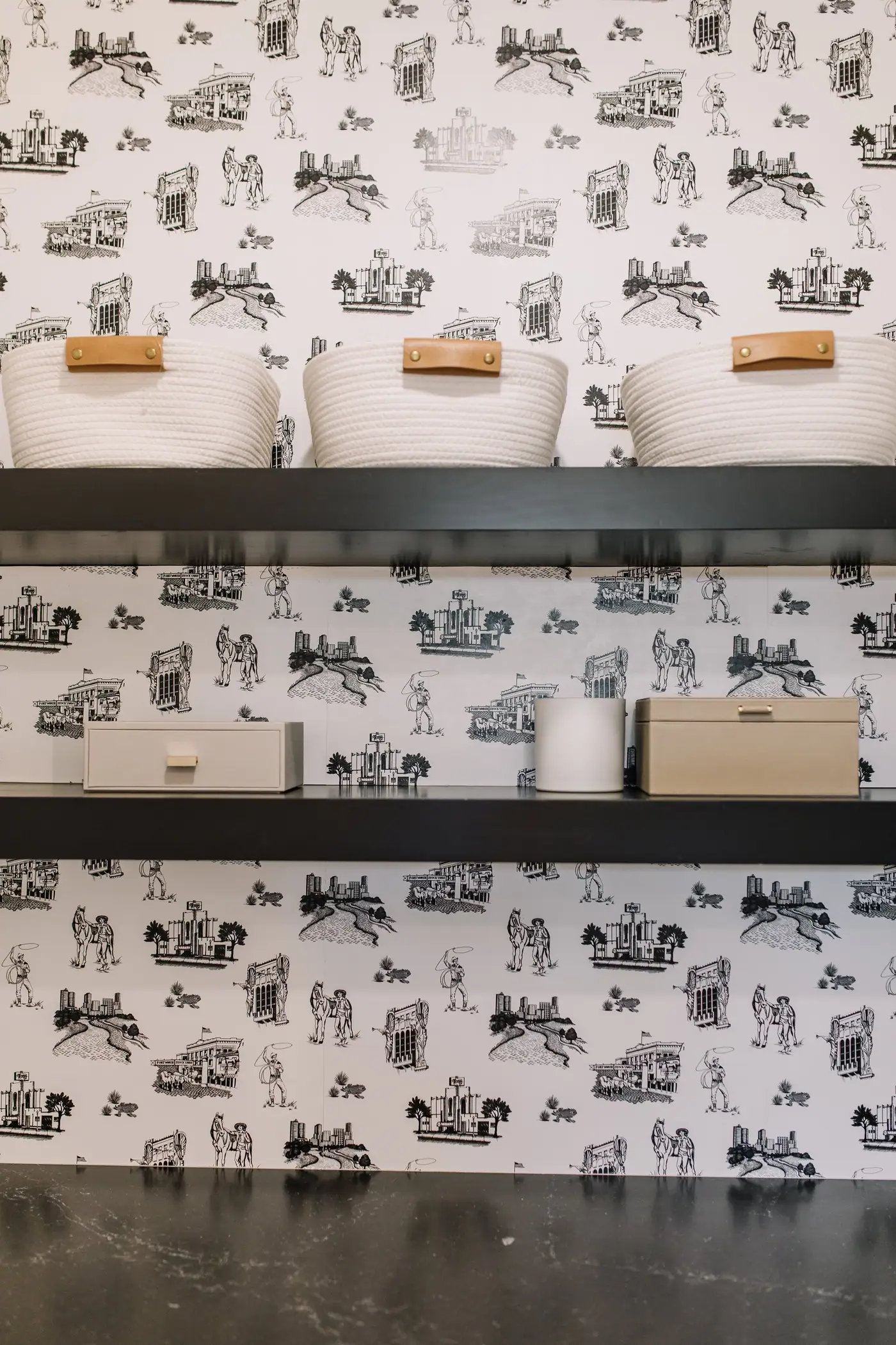 A wallpapered coffee bar with floating shelves and a dark stone counter in a Fort Worth custom home