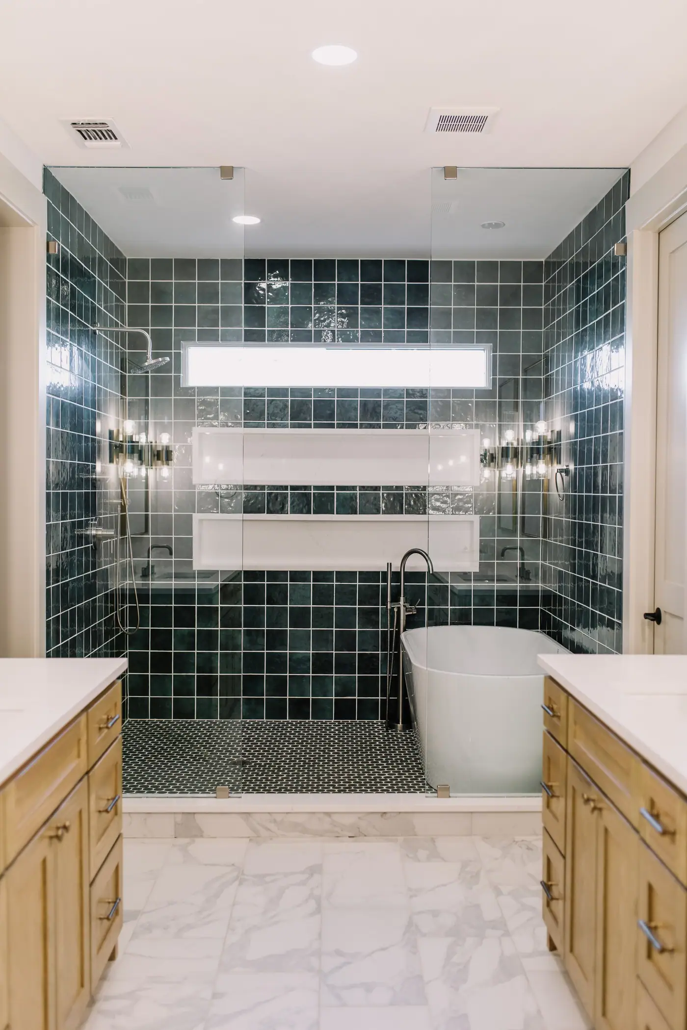 A wet room with a freestanding tub inside a green-tiled walk-in shower at a Fort Worth custom home