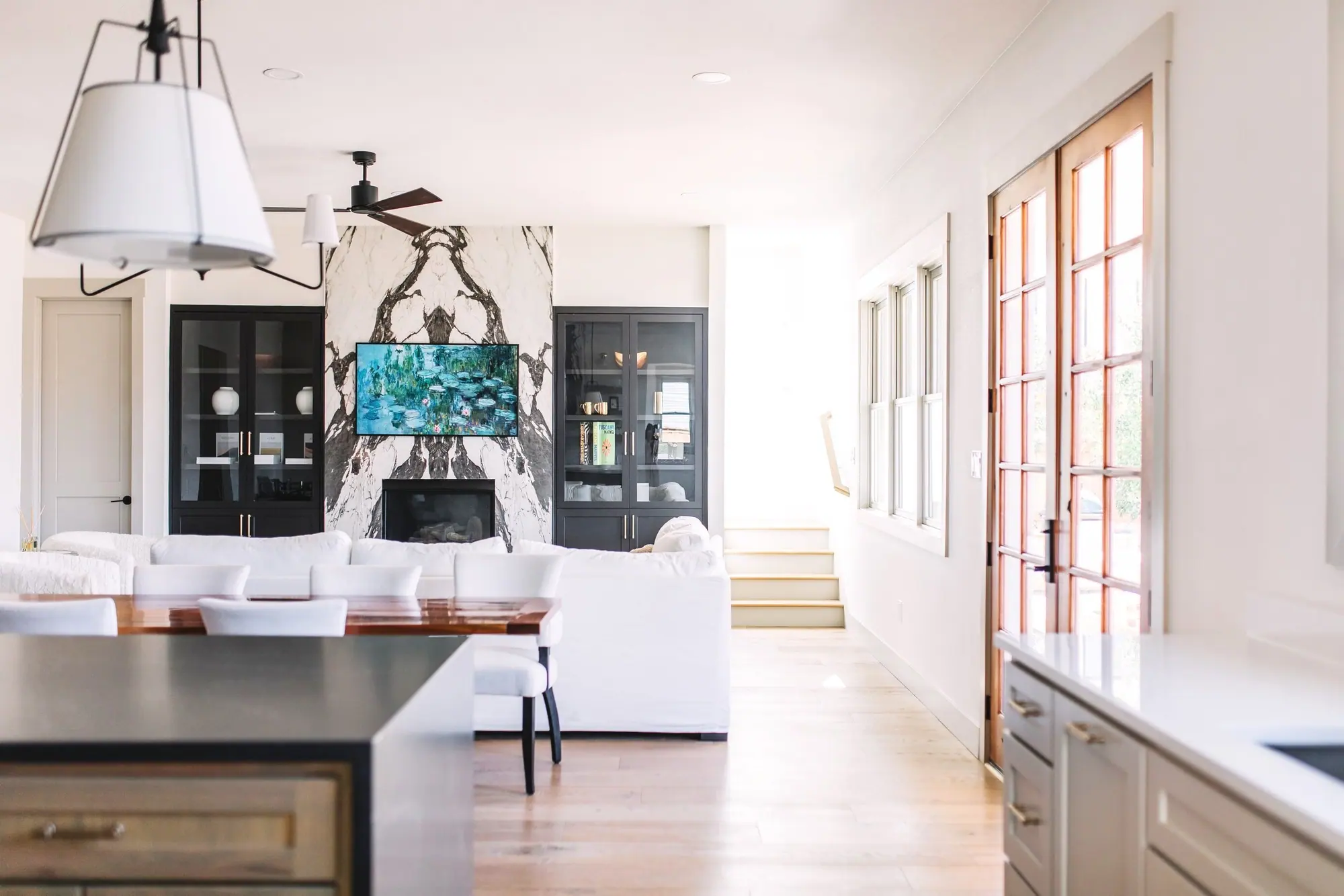 A book-matched marble open-plan great room designed and built by 6th Ave Homes in Fort Worth