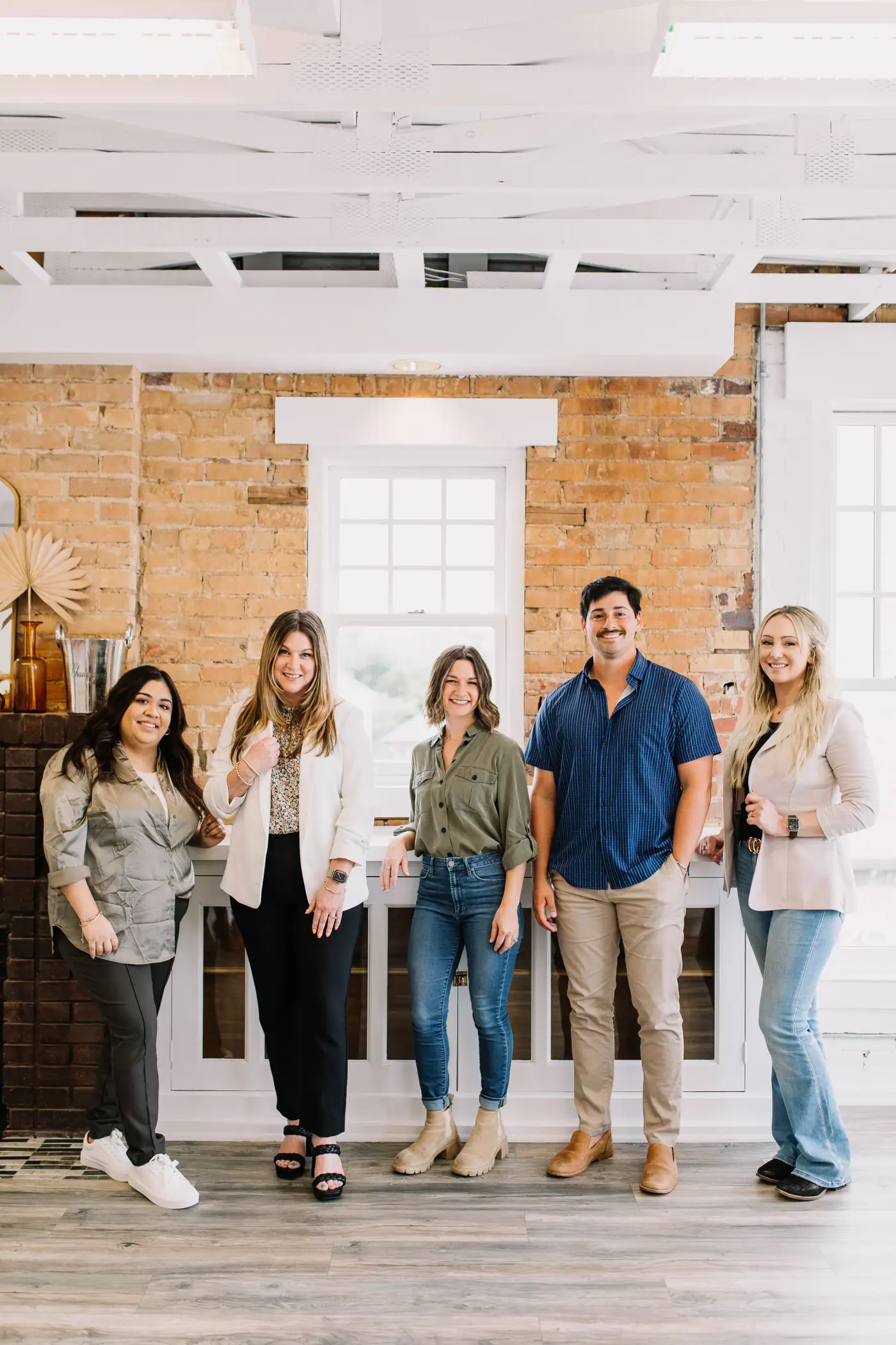 Five 6th Ave Homes agents standing together in the Fort Worth office