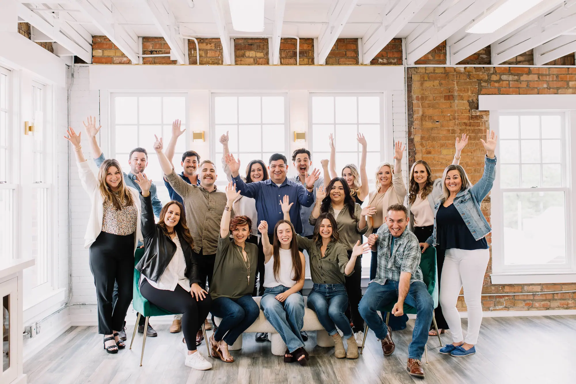 The 6th Ave Homes agent team cheering, arms up, in the Fort Worth office