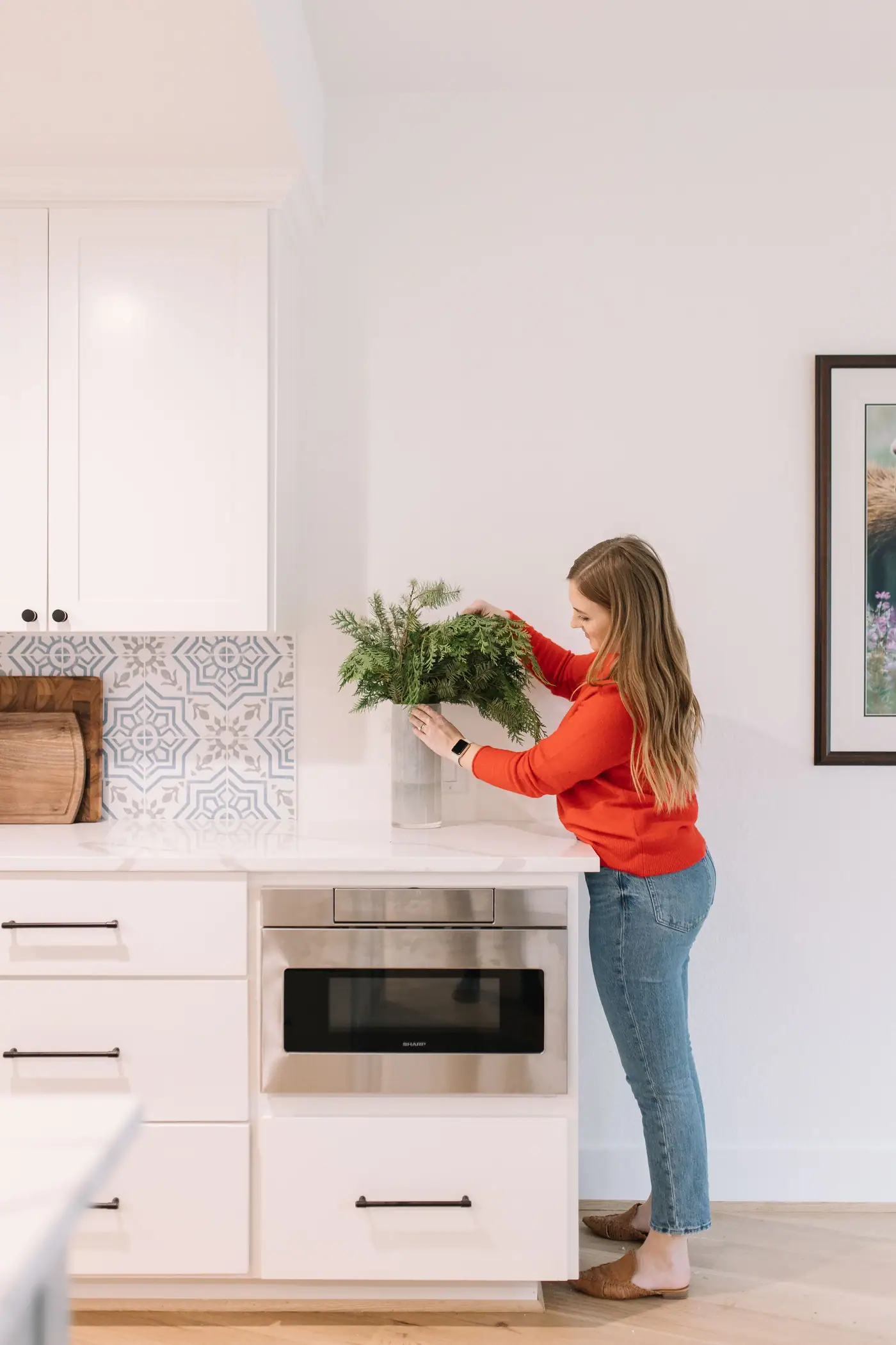 A bright, freshly renovated Fort Worth kitchen with a marble island and brass hardware