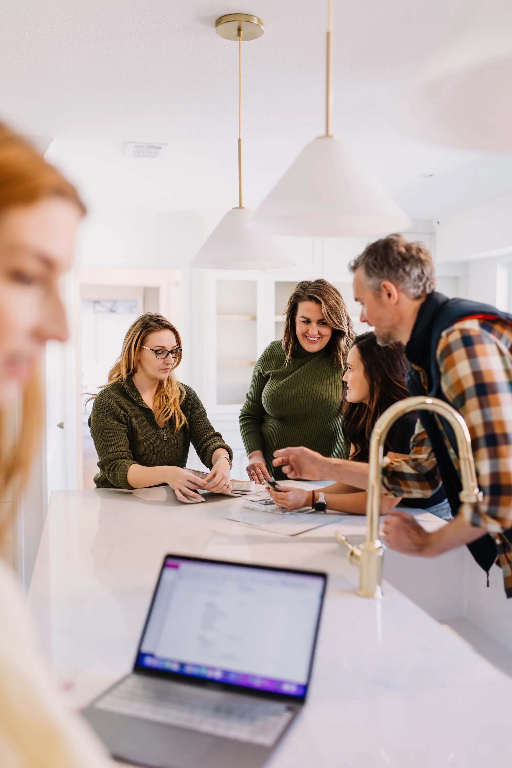 Designers, builders and agents working together around a kitchen island