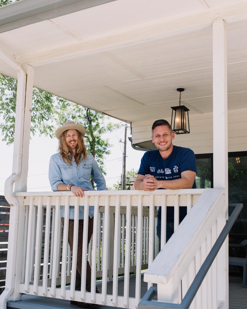 Founders Jamey Ice and Jimmy Williams smiling at the rail of a restored Fort Worth front porch