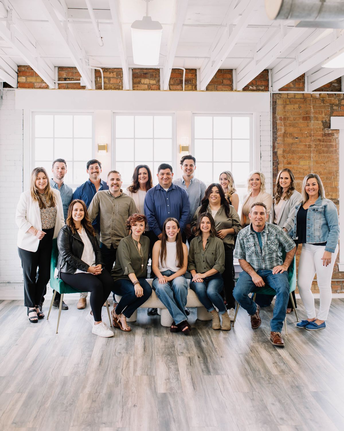 The 6th Ave Homes team gathered in the brick-walled loft of their Fort Worth office