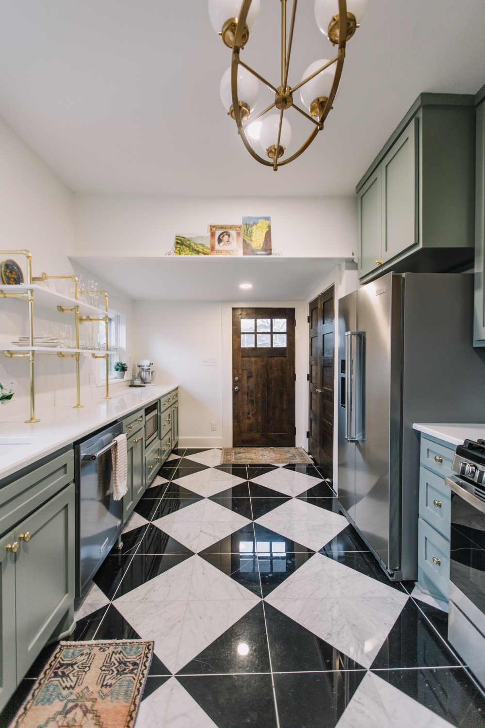 Checkerboard-marble galley kitchen with sage cabinets and brass fixtures in a restored Fairmount home, Fort Worth