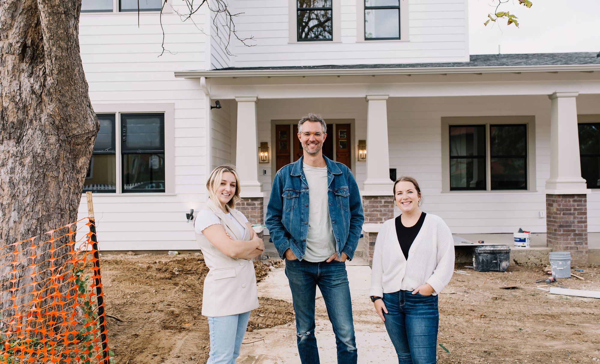 Three members of the 6th Ave Homes team outside a custom home they designed and built in Fort Worth, the yard not yet landscaped
