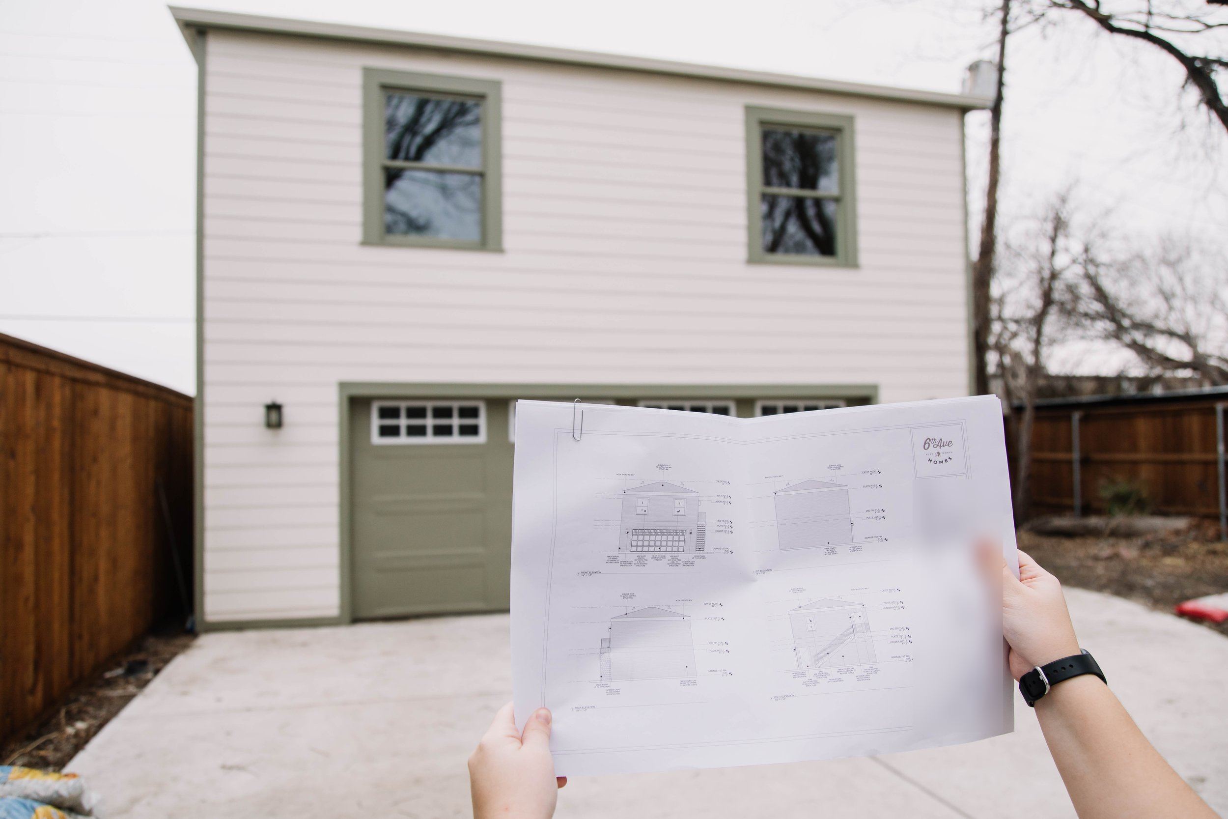 A finished two-story garage apartment by 6th Ave Homes in Fort Worth, with the elevation plans in hand