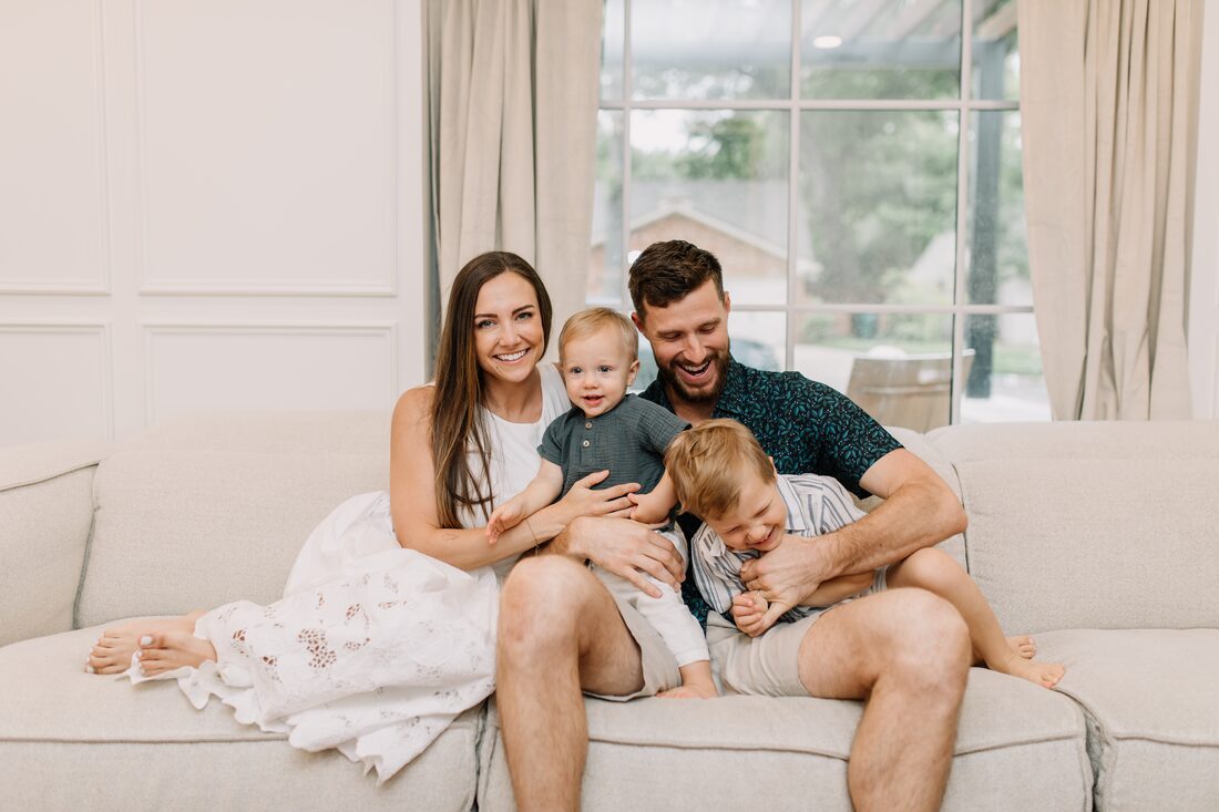A Fort Worth family laughing together in the bright living room of their new home