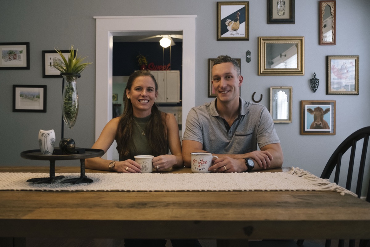 A Fort Worth couple at home with 6th Ave Homes mugs, in the house they bought