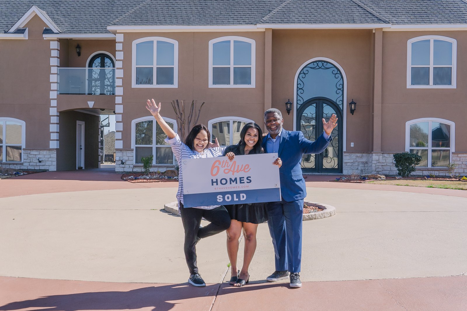 A Fort Worth family celebrating behind a 6th Ave Homes SOLD sign on closing day
