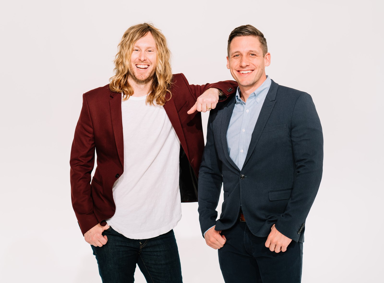 Portrait of 6th Ave Homes founders Jamey Ice and Jimmy Williams, arm in arm and laughing