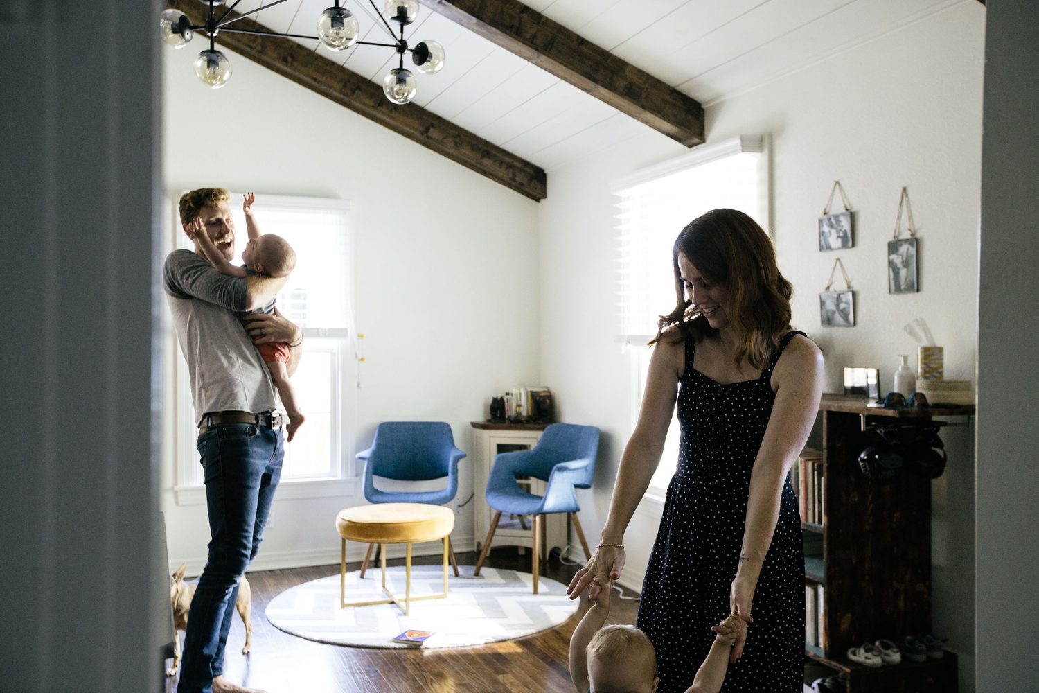 A young family playing together in the opened, vaulted great room of the Fort Worth home 6th Ave Homes remodeled for them