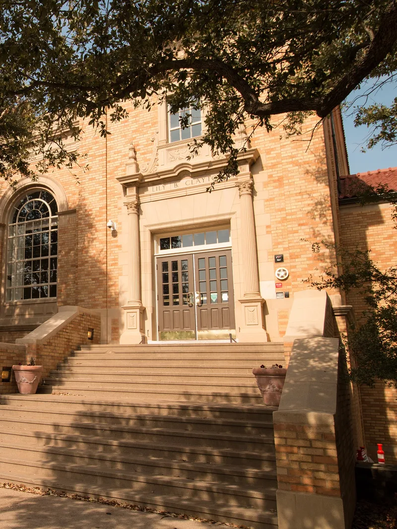 The front steps and double doors of Lily B. Clayton Elementary, with the school’s name carved over the entrance.