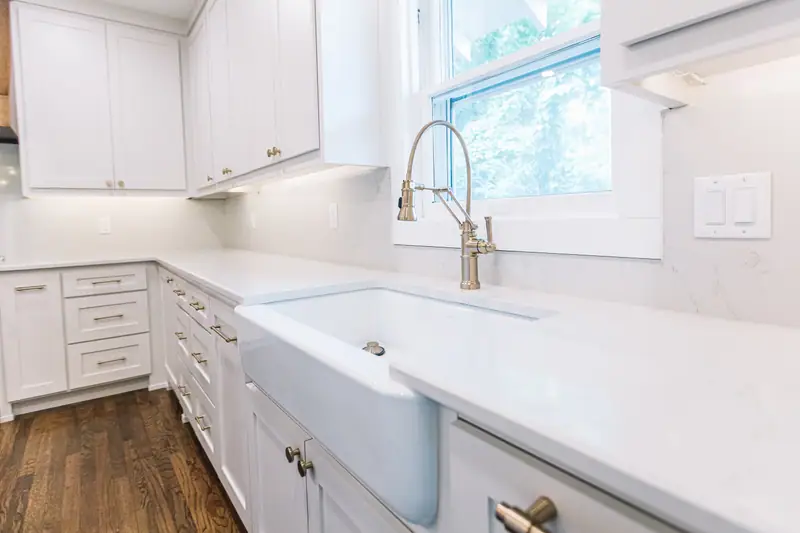 Mistletoe Heights Kitchen & Primary Expansion: the farmhouse sink under the window, by 6th Ave Homes in Fort Worth