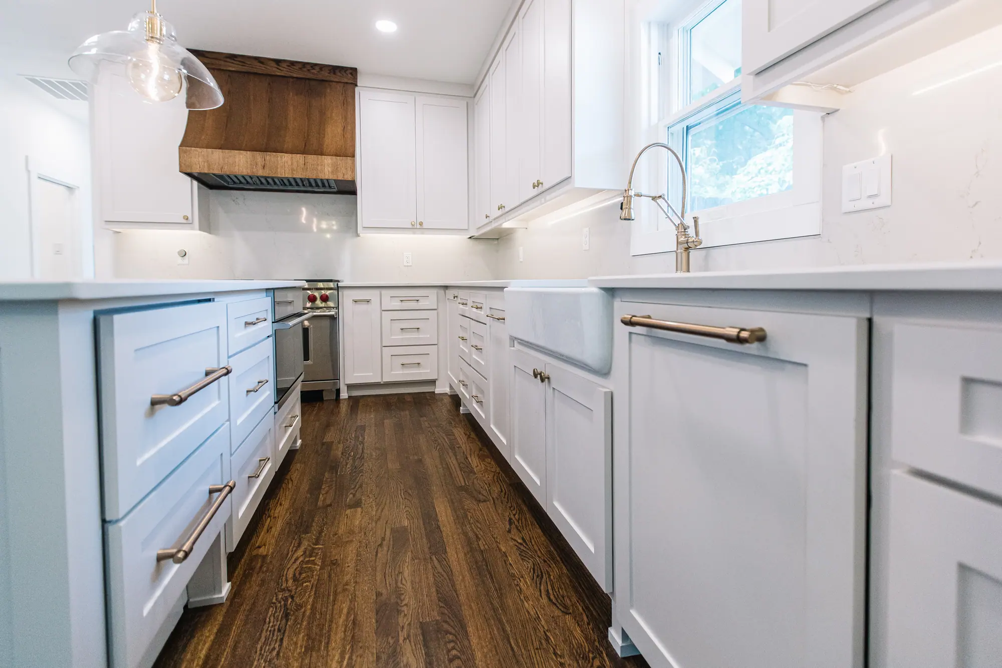 The long run of cabinets to the farmhouse sink, by 6th Ave Homes in Fort Worth
