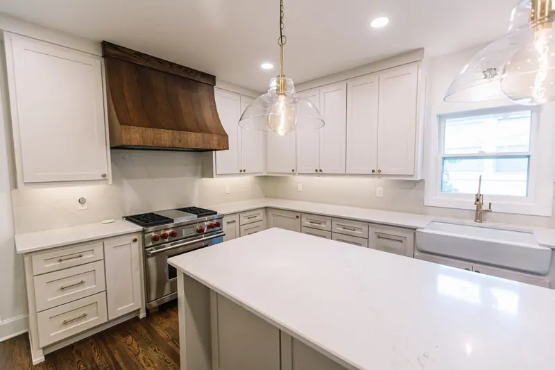 Mistletoe Heights Kitchen & Primary Expansion: the expanded kitchen, island and stained wood hood, by 6th Ave Homes in Fort Worth