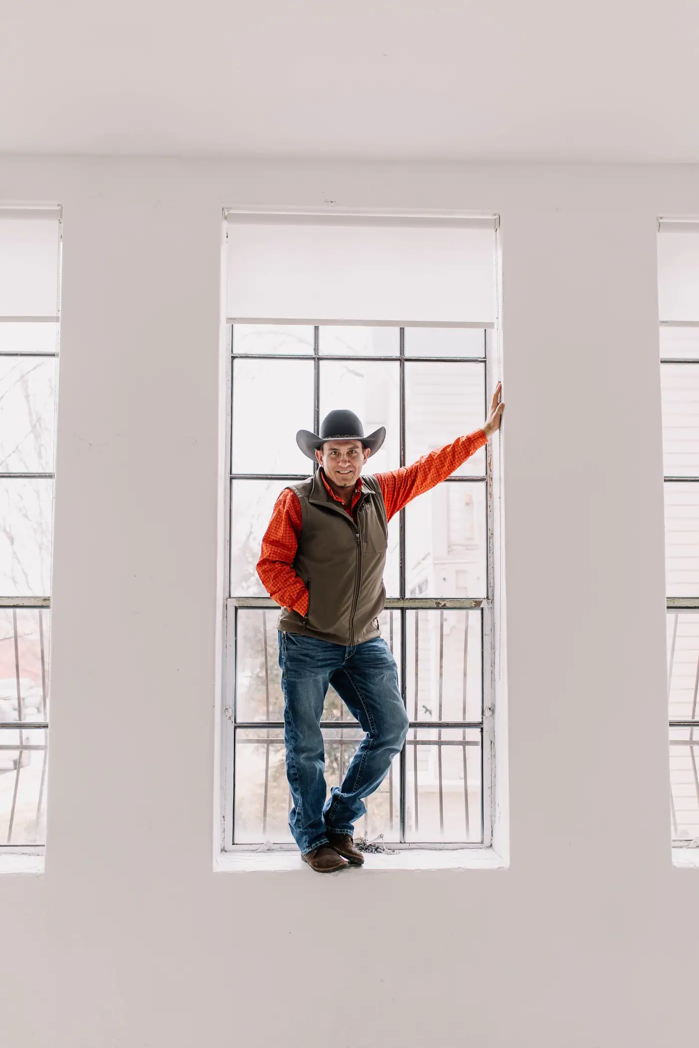 Brian St. Clair standing in a tall window