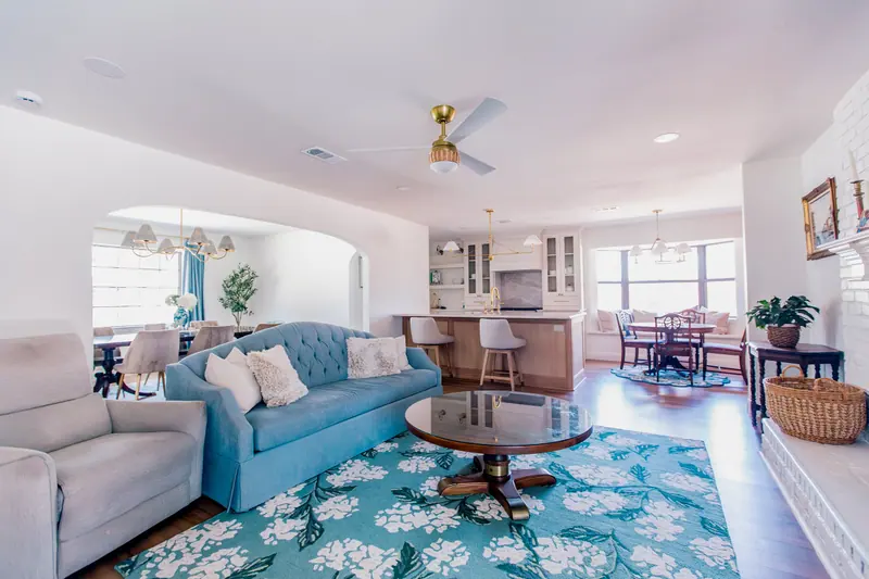An opened Fort Worth floor plan: a living room with sightlines through an arched opening to the dining room and across to the kitchen island